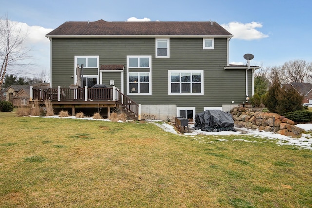 rear view of property with a deck and a lawn