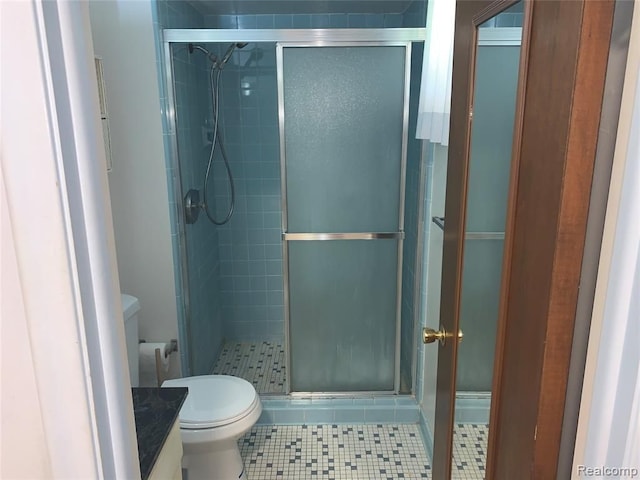 bathroom with toilet and a shower stall