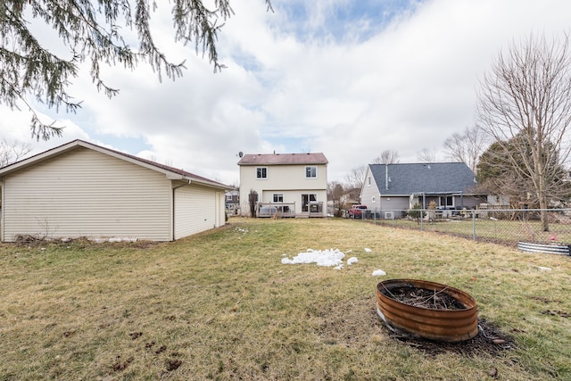 back of property featuring a lawn and fence