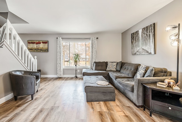 living room featuring light wood-style floors and baseboards