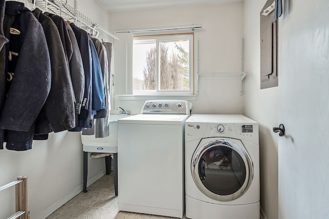 laundry area with laundry area, baseboards, separate washer and dryer, and a sink