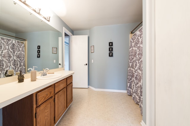 bathroom featuring baseboards and vanity