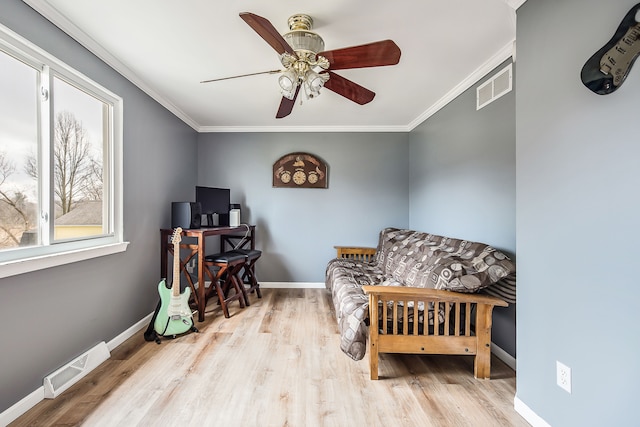 living area with ornamental molding, visible vents, and baseboards