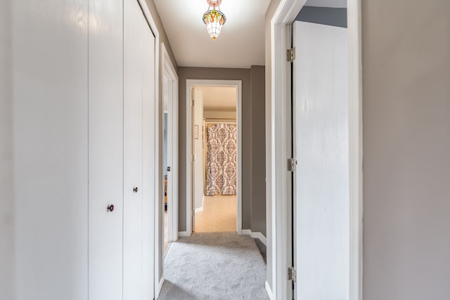 corridor featuring carpet and baseboards