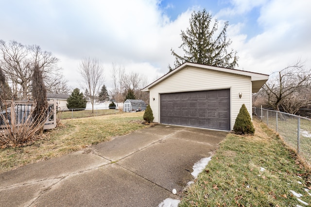 detached garage featuring fence