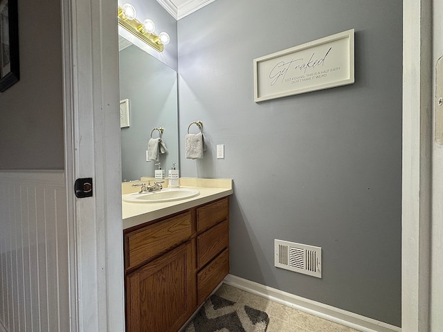 bathroom featuring visible vents, vanity, and baseboards