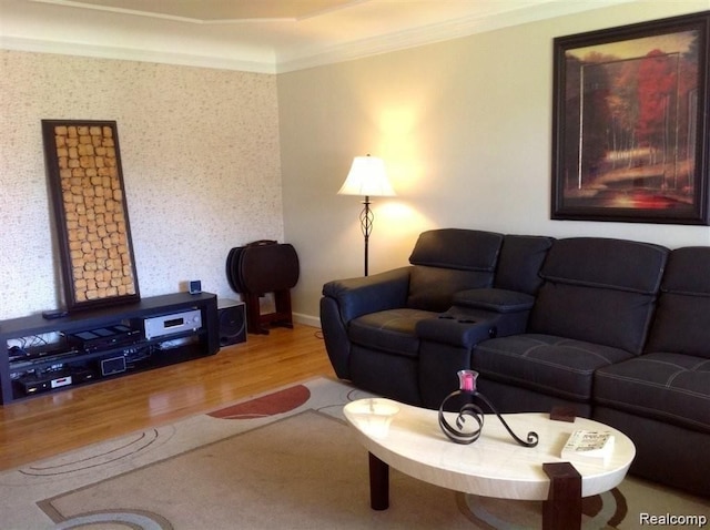 living room featuring baseboards, ornamental molding, and wood finished floors