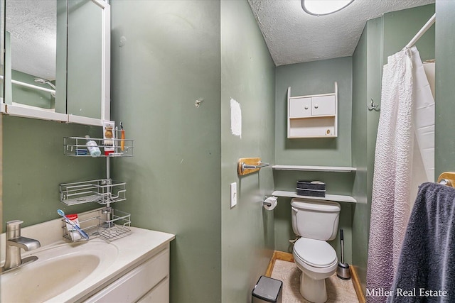 bathroom featuring a textured ceiling, curtained shower, vanity, and toilet