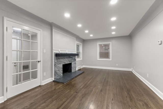 unfurnished living room with a fireplace, baseboards, dark wood-style flooring, and recessed lighting