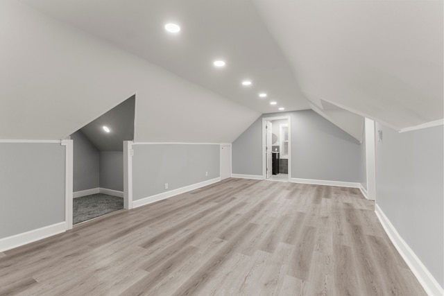 bonus room with vaulted ceiling, light wood finished floors, recessed lighting, and baseboards