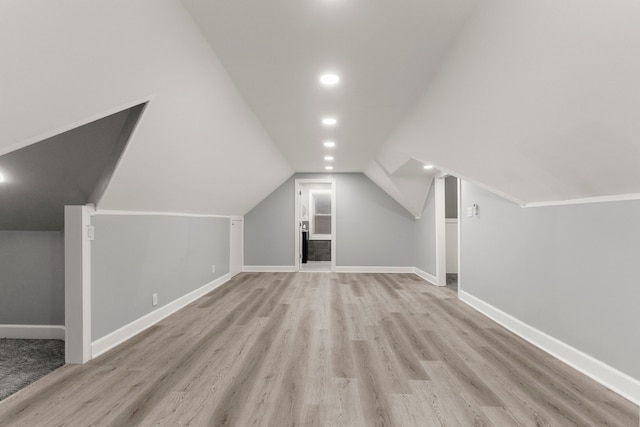 bonus room with baseboards, recessed lighting, lofted ceiling, and light wood-style floors