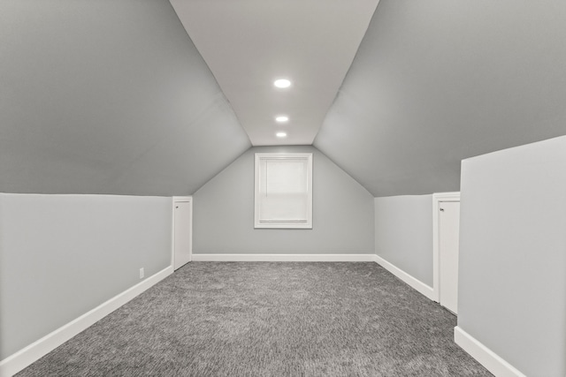 bonus room with carpet, baseboards, and vaulted ceiling