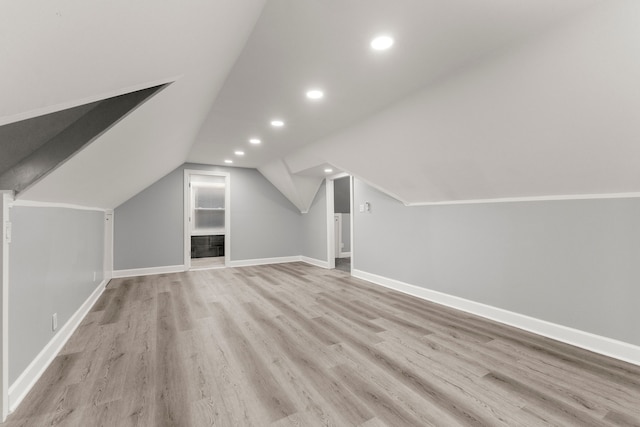 additional living space featuring recessed lighting, vaulted ceiling, baseboards, and wood finished floors