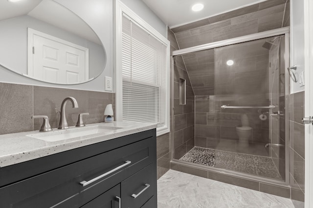 full bathroom featuring a shower stall, tasteful backsplash, and vanity