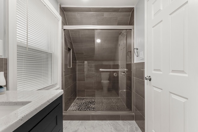 bathroom featuring a shower stall and vanity