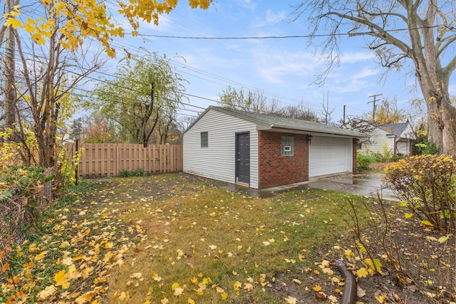 detached garage featuring fence