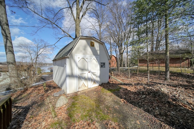 view of shed featuring fence