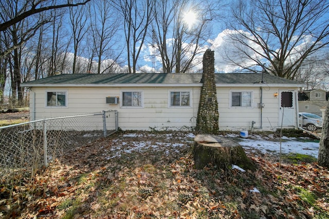 rear view of house with fence and a chimney