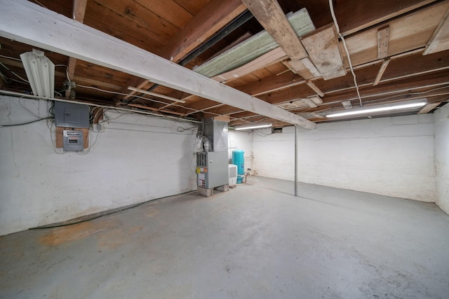 unfinished basement with heating unit and electric panel