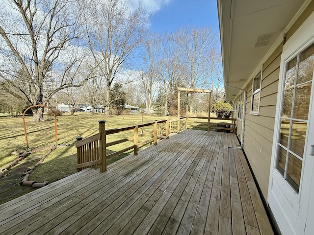 wooden deck featuring a yard