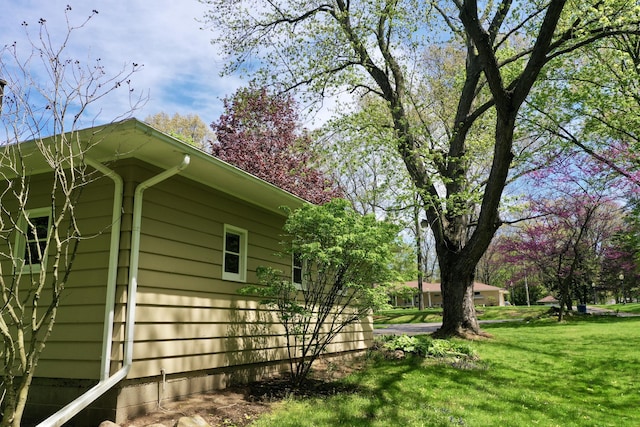 view of side of home with a lawn