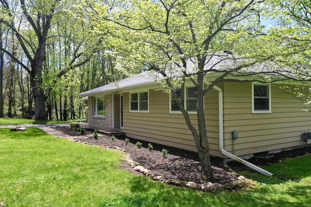back of property featuring a yard