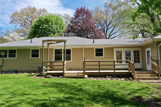 back of house featuring a deck, a yard, and a chimney