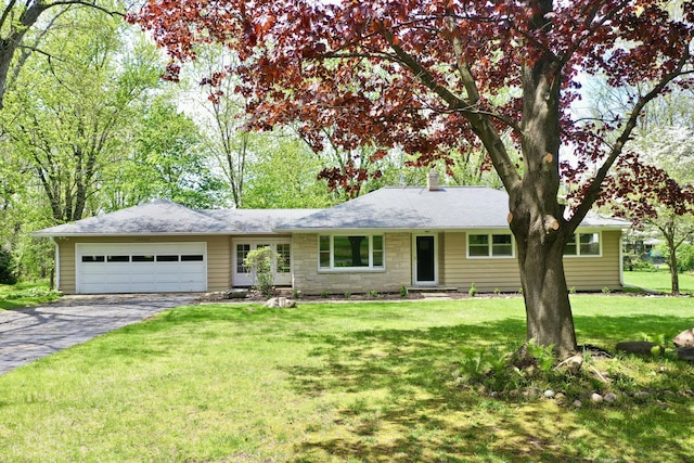 ranch-style house with asphalt driveway, an attached garage, a chimney, and a front lawn