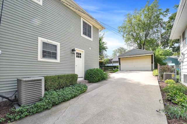 view of home's exterior featuring central AC, an outdoor structure, and a detached garage