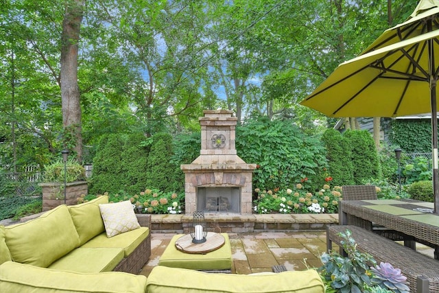 view of patio / terrace with an outdoor living space with a fireplace and outdoor dining area