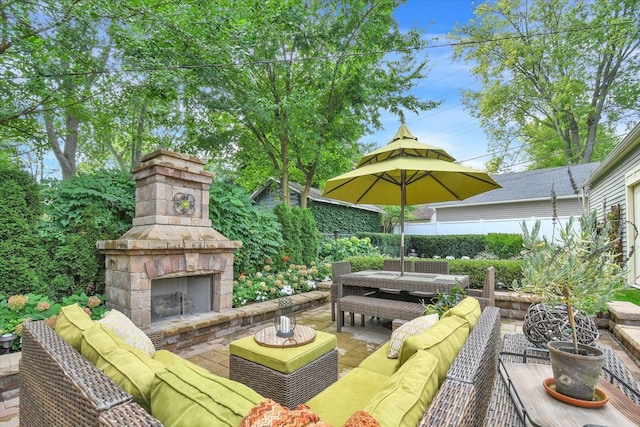 view of patio featuring an outdoor living space with a fireplace, fence, and outdoor dining space