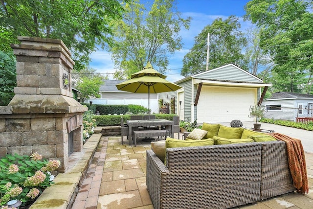 view of patio / terrace featuring an outbuilding, outdoor dining area, outdoor lounge area, and fence