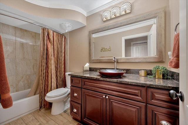 bathroom with ornamental molding, vanity, toilet, and shower / bath combo with shower curtain