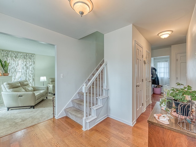 stairs with baseboards and wood finished floors