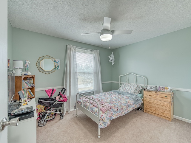 bedroom featuring carpet, ceiling fan, a textured ceiling, and baseboards