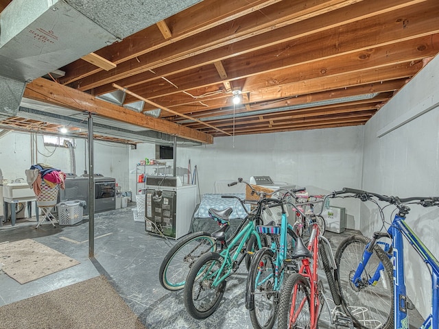 unfinished below grade area with washing machine and dryer and a sink