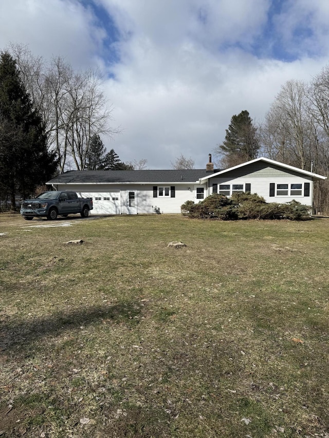 view of front facade featuring a chimney and a front yard