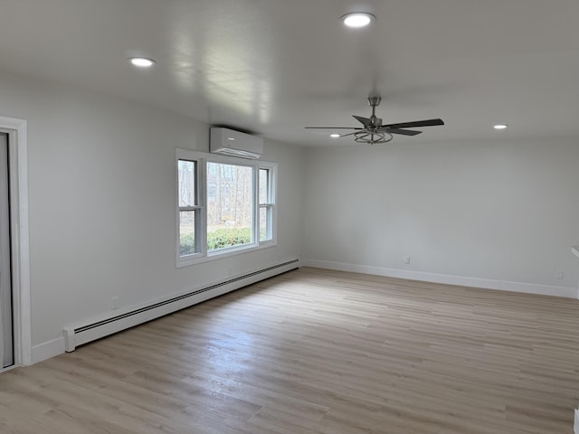 empty room with light wood finished floors, baseboards, a baseboard radiator, an AC wall unit, and recessed lighting