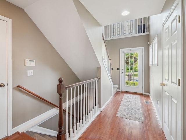 interior space featuring hardwood / wood-style floors, visible vents, and baseboards