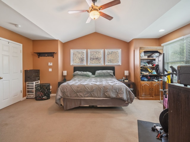 bedroom featuring a ceiling fan, lofted ceiling, carpet flooring, and baseboards