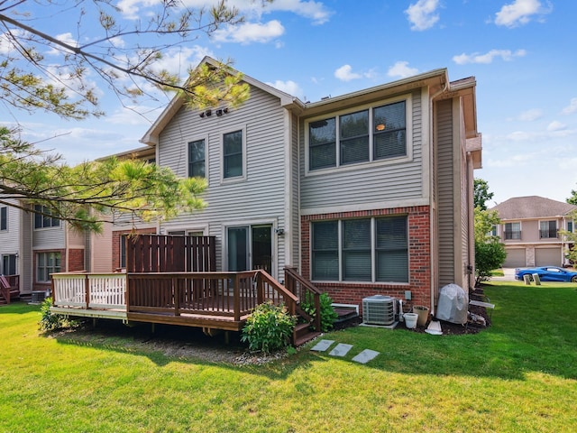 rear view of property featuring brick siding, a yard, a deck, and central AC unit