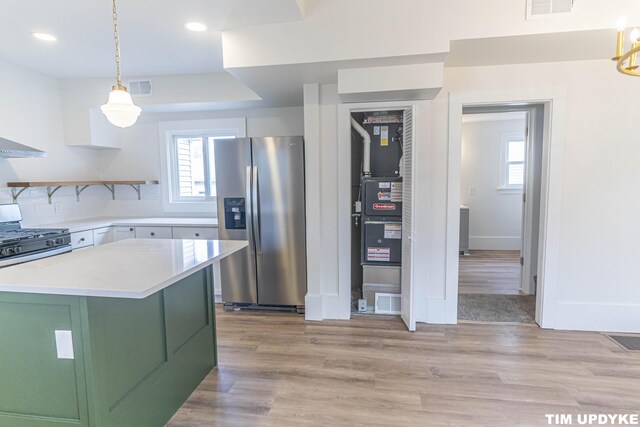 kitchen featuring light countertops, appliances with stainless steel finishes, light wood-type flooring, and visible vents