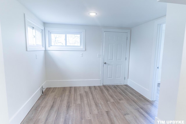 unfurnished room with light wood-style flooring and baseboards