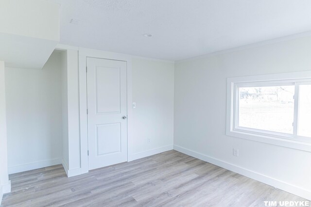 interior space featuring light wood-style flooring and baseboards