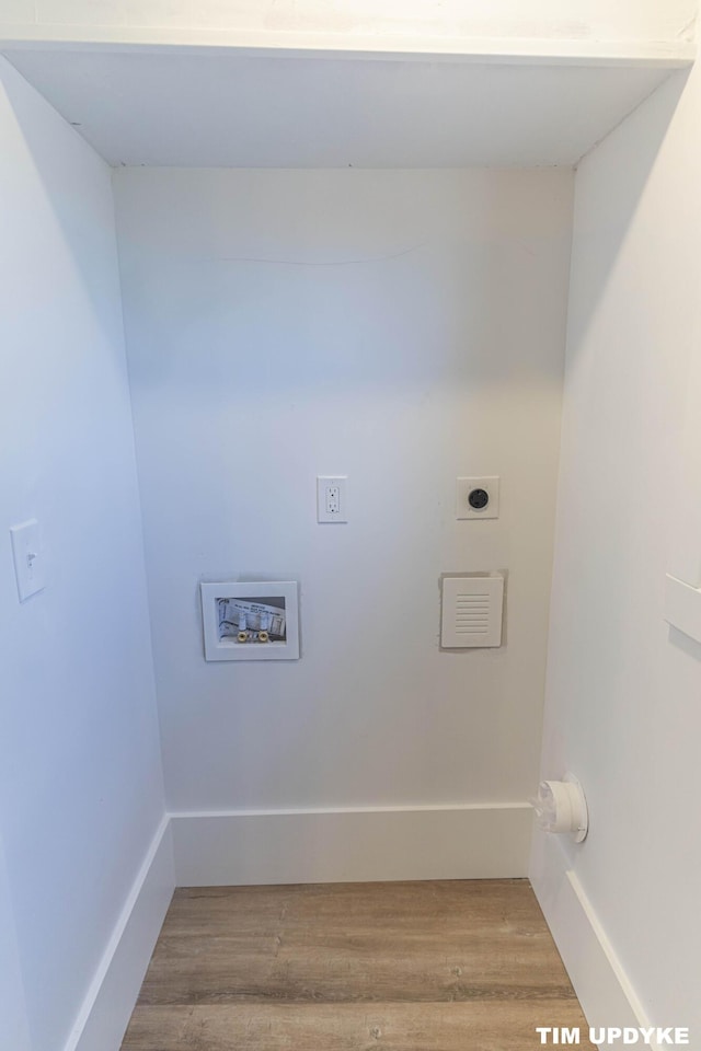 washroom featuring hookup for a washing machine, hookup for an electric dryer, baseboards, and wood finished floors