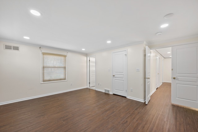 unfurnished room featuring baseboards, visible vents, and dark wood-style flooring