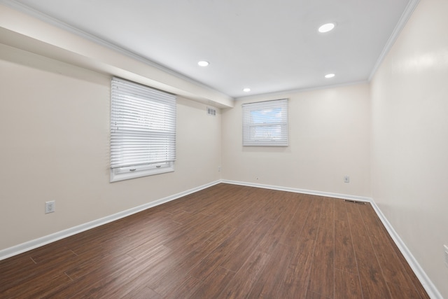 unfurnished room featuring crown molding, wood finished floors, and baseboards