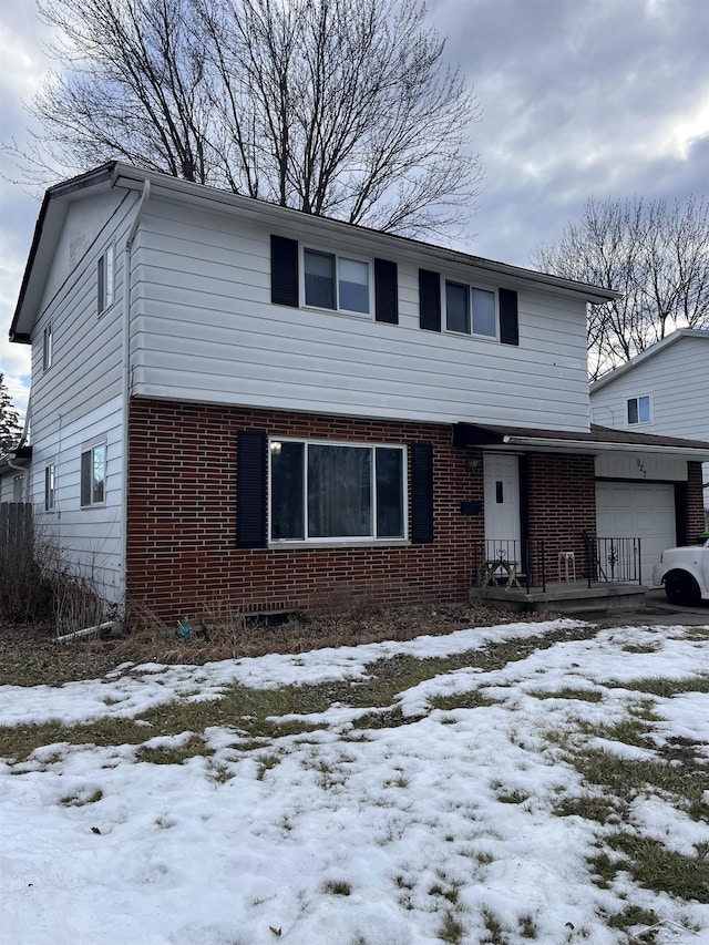 view of front of property with a garage and brick siding