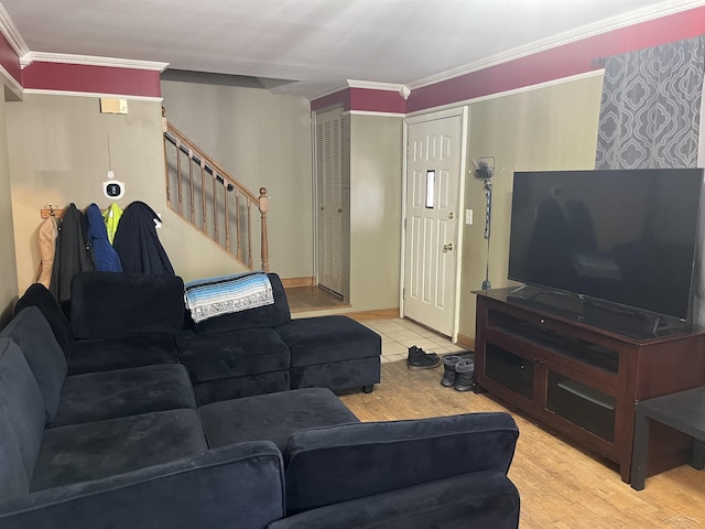 living area featuring ornamental molding, stairway, baseboards, and wood finished floors