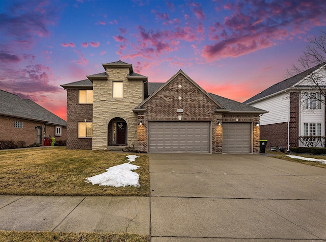 view of front of home featuring a garage, driveway, a shingled roof, a front lawn, and brick siding